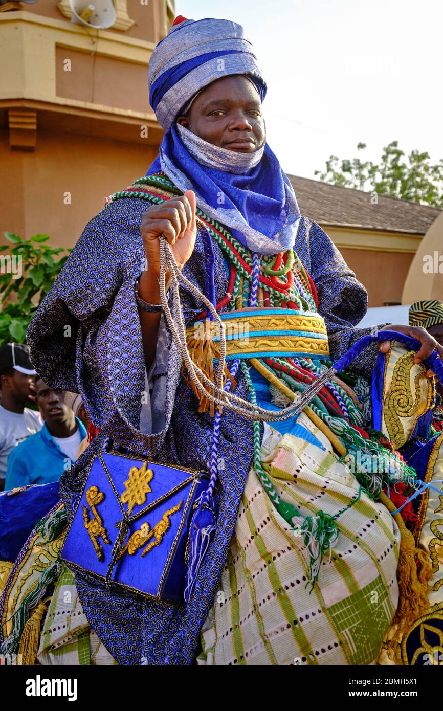 Nobleman rider dressed in a colourful outfit mounting an embellished horse  during the celebration of a durbar. A durbar is a celebration in northern N  Stock Photo - Alamy