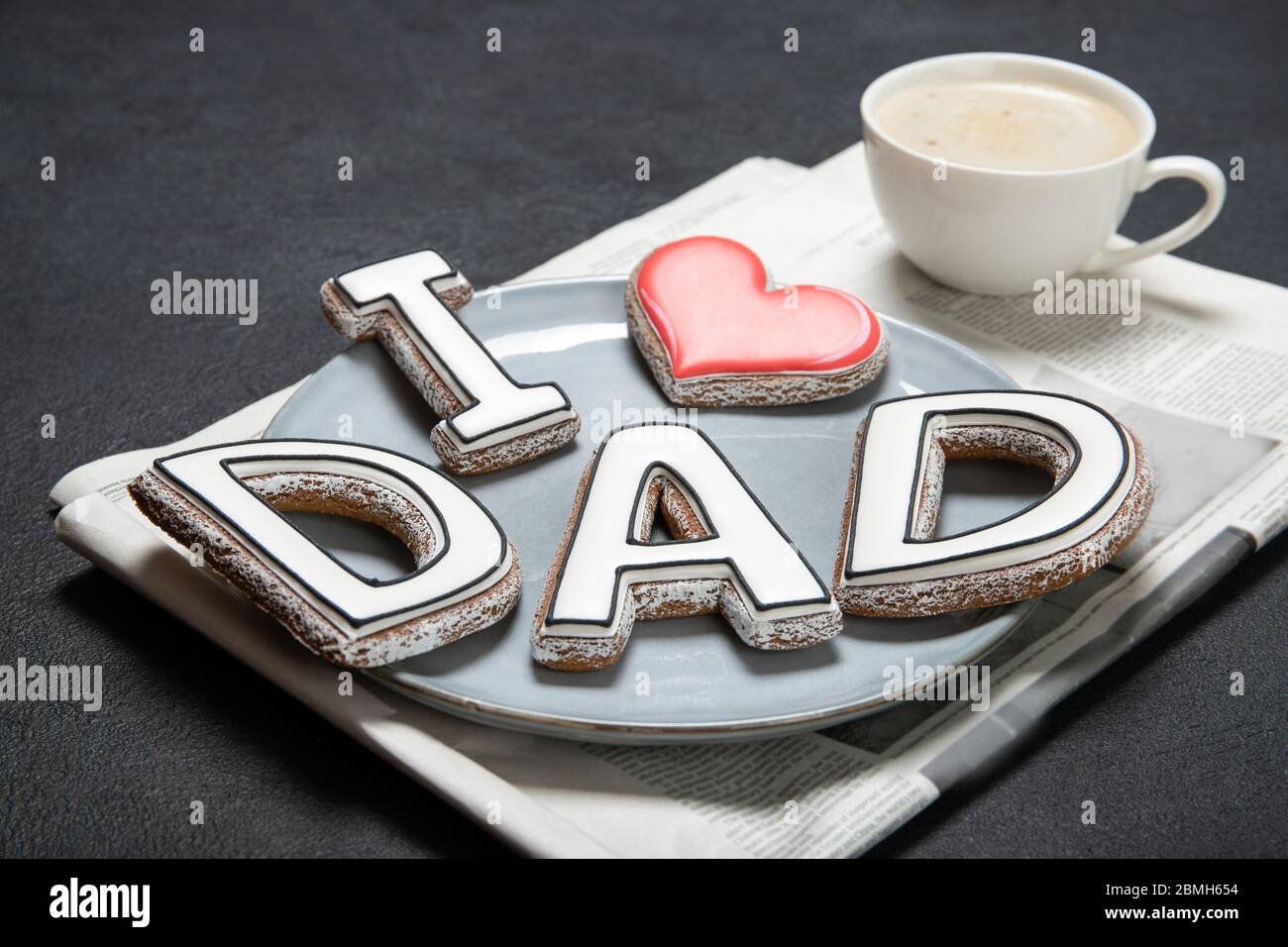 Happy Father's Day concept. Tasty cookies and cup of coffee on wooden background Stock Photo