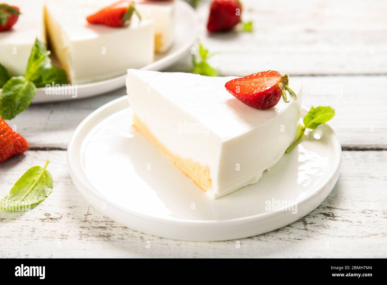 Homemade cheesecake with strawberries on a wooden background. Close-up Stock Photo