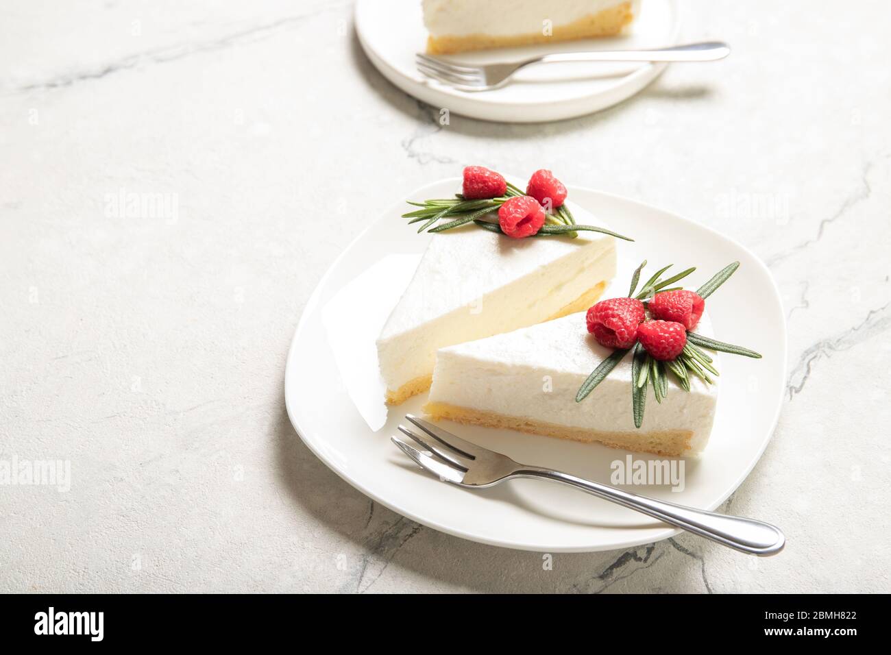 Plate with delicious raspberry cheesecake. On a wooden background Stock Photo
