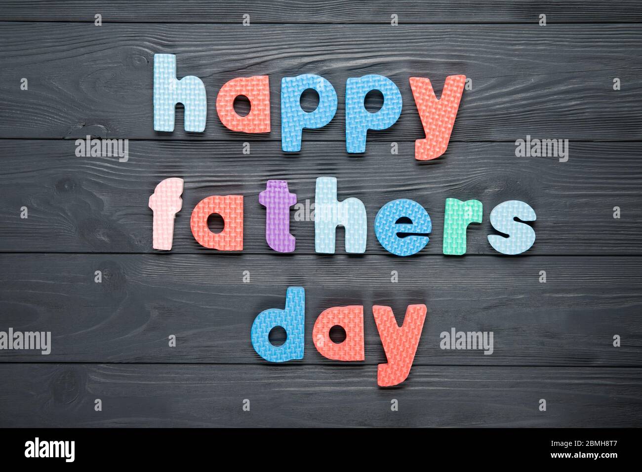 Text happy dad's day on a gray wooden background Stock Photo