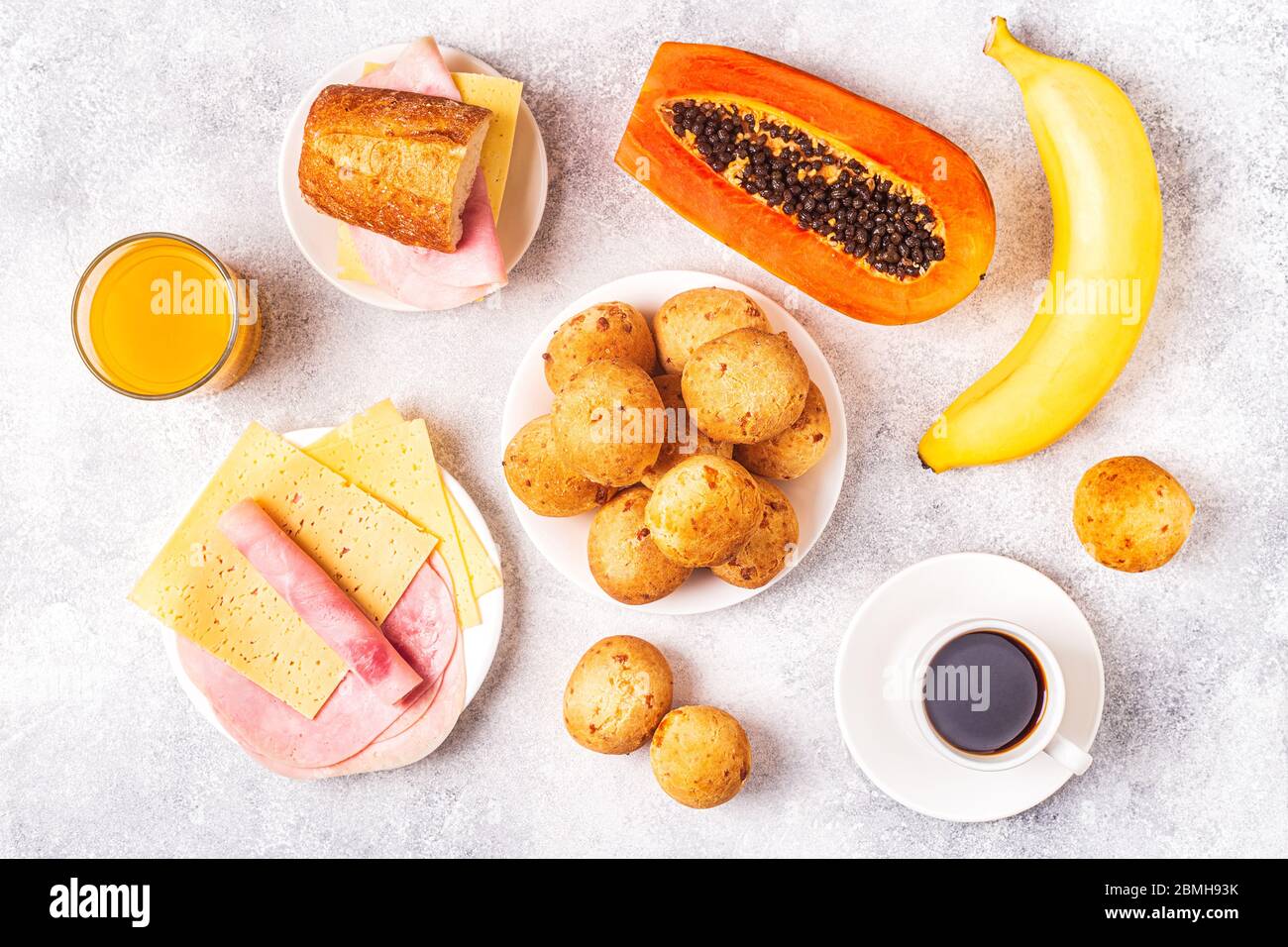 Traditional Brazilian breakfast cheese bread, coffee, ripe fruit, top