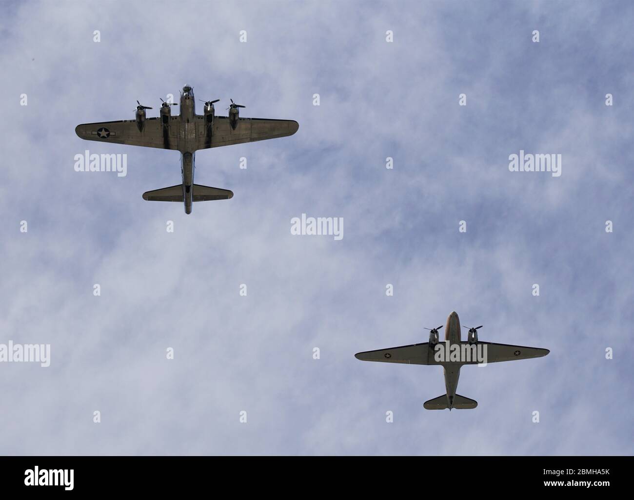 A B-17 Flying Fortress and C-47 Skytrain fly in formation to commemorate VE Day Stock Photo