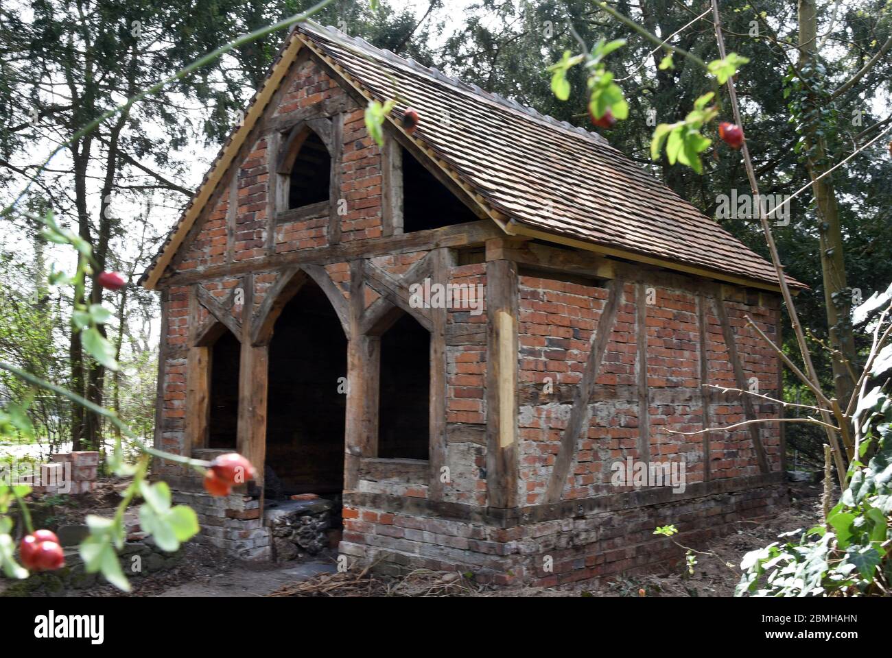 16 April 2020, Saxony-Anhalt, Wörlitz: Without its bark root cover, the bathhouse built some 235 years ago by Prince Leopold III Friedrich Franz von Anhalt Dessau (1740-1817) stands in Wörlitz Park. The half-timbered house, which is actually covered with bark wood and known as the Borkenhäuschen or Wurzelhütte, is currently being restored. Severe damage to the load-bearing structure, as well as to the outer bark and inner decorative cladding attached to it, will have to be repaired in the coming weeks. The Wörlitz Park is part of today's UNESCO World Heritage Site Dessau-Wörlitz Garden Kingdom Stock Photo