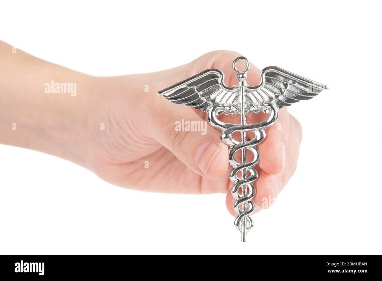 Female hand holds a two-snake design Hermes symbol. Caduceus as a symbol of medicine. Close-up shot, isolated on white. Stock Photo