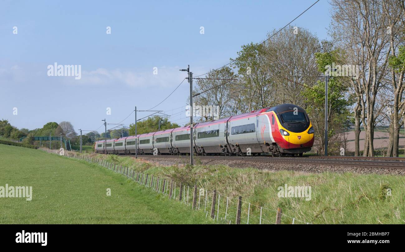 Virgin trains Alstom Pendolino train on the west coast mainline in Cumbria Stock Photo