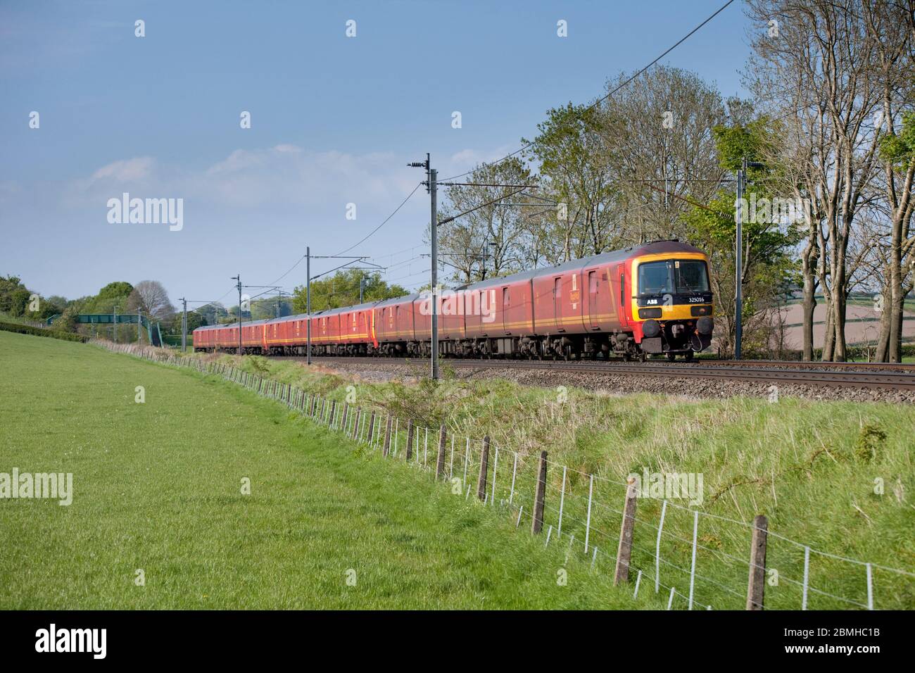 3 Royal Mail Class 325 postal trains pass Wellheads (north of Carnforth) on the scenic west coast mainline in Cumbria with a mail train Stock Photo