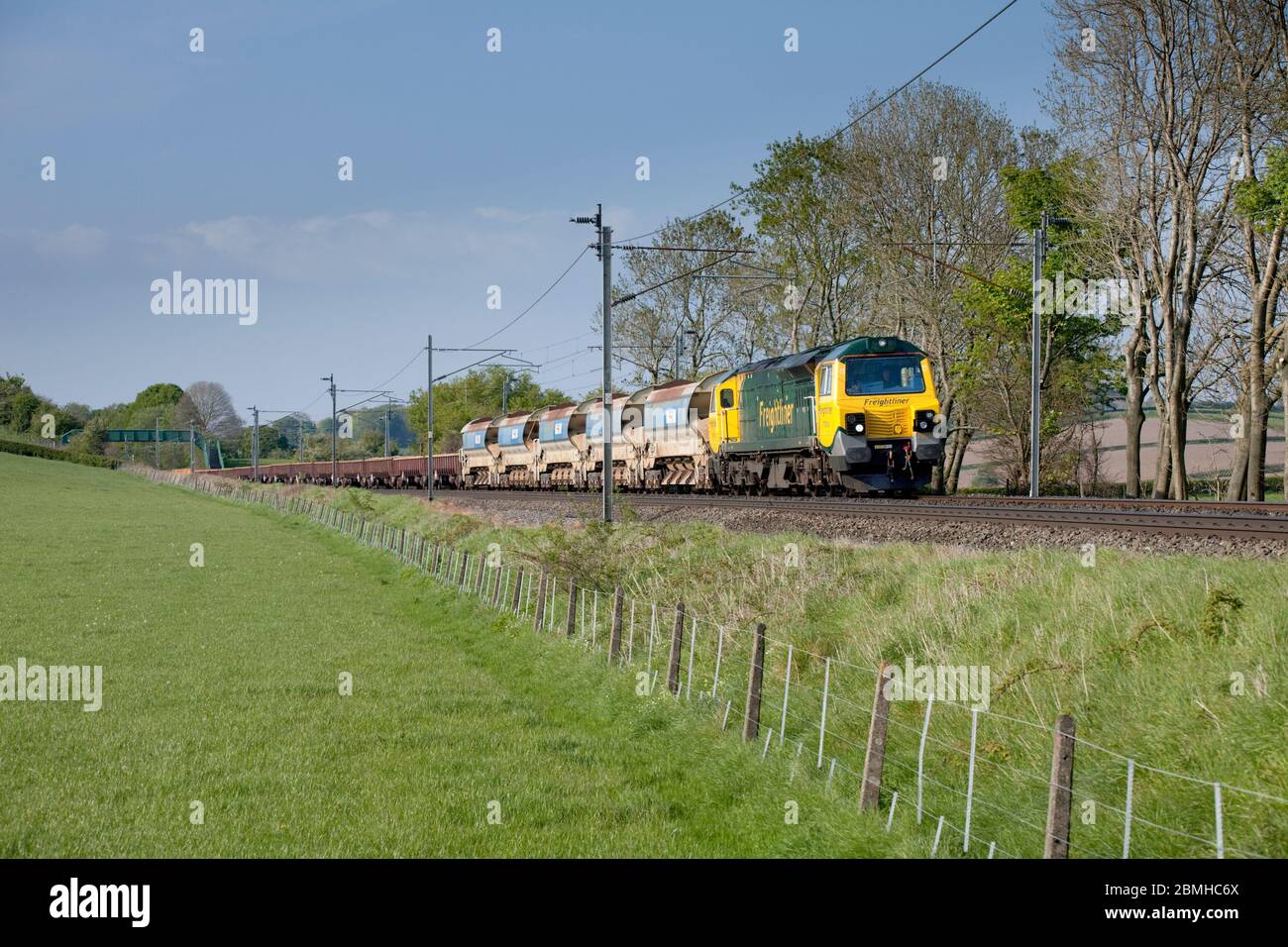 Freightliner GE class 70 diesel locomotive 70016 on the electrified west coast mainline with a freight train carrying materials for Network Rail Stock Photo