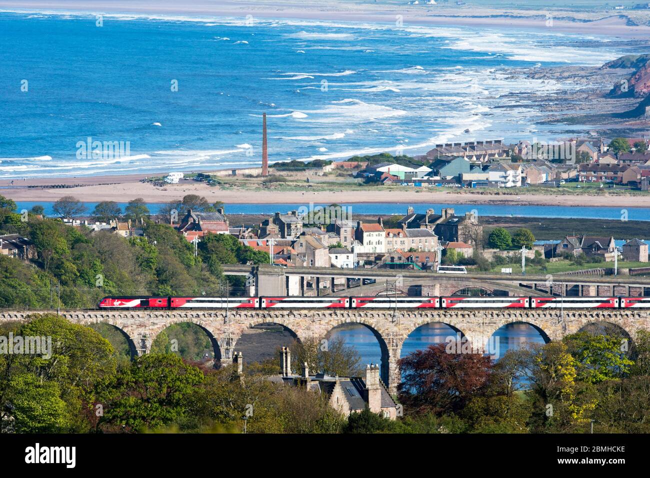 A Virgin train crosses the Royal Border rail bridge which spans the River Tweed at Berwick-Upon-Tweed, Northumberland, England. Stock Photo