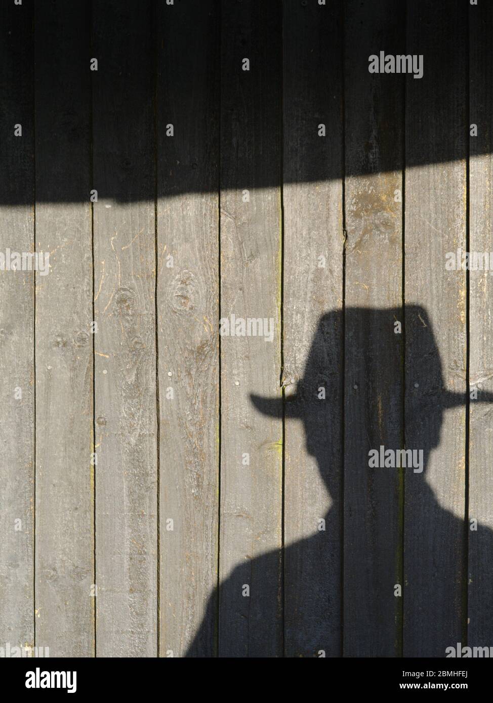 Shadow of man in felt hat Stock Photo
