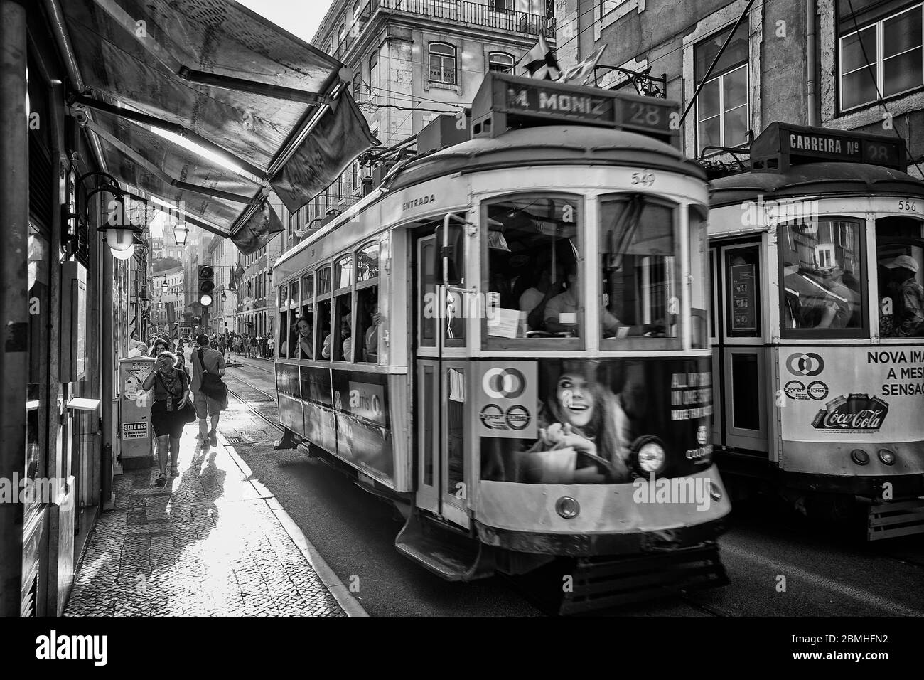 A trolley moves along a street in the Old Town area of Lisbon, Portugal. Stock Photo