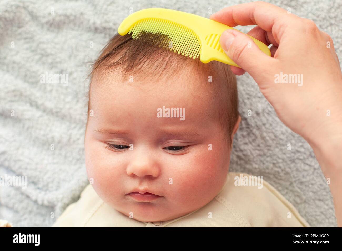 Beautiful baby girl with mother combing. Baby Hair Combs. Scalp Massage  Stock Photo - Alamy