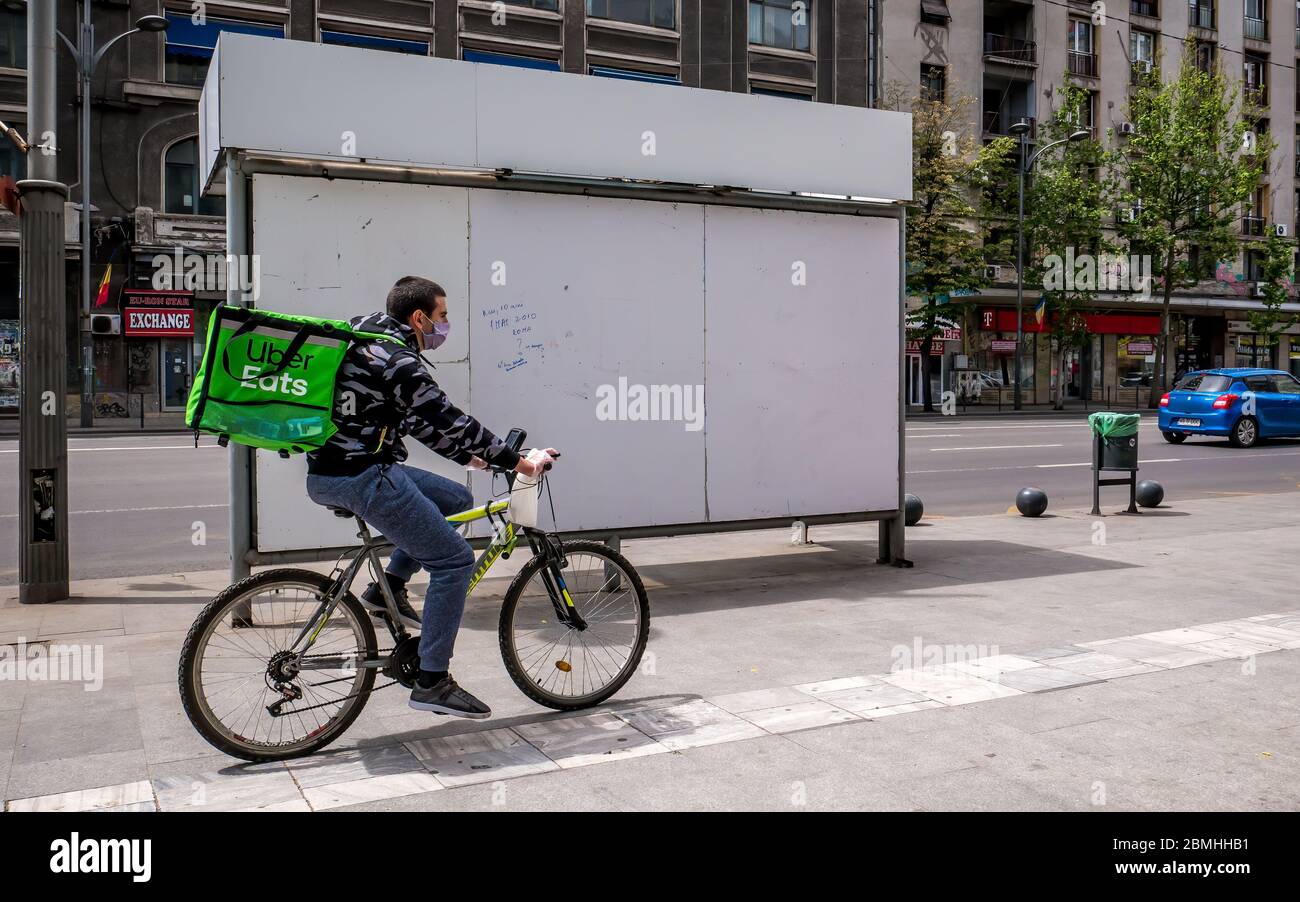 Bucharest/Romania - 05.07.2020: Uber eats courier on a bicycle delivering the order. Stock Photo
