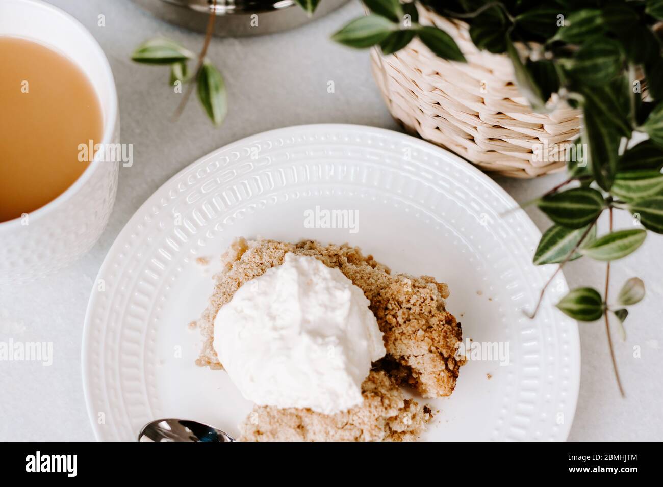 Sweet treat, dessert, apple crumble, apple pie, cream, tea, afternoon tea, relaxing concept, plant, blogging photo, blog image, white plate, food, eat Stock Photo