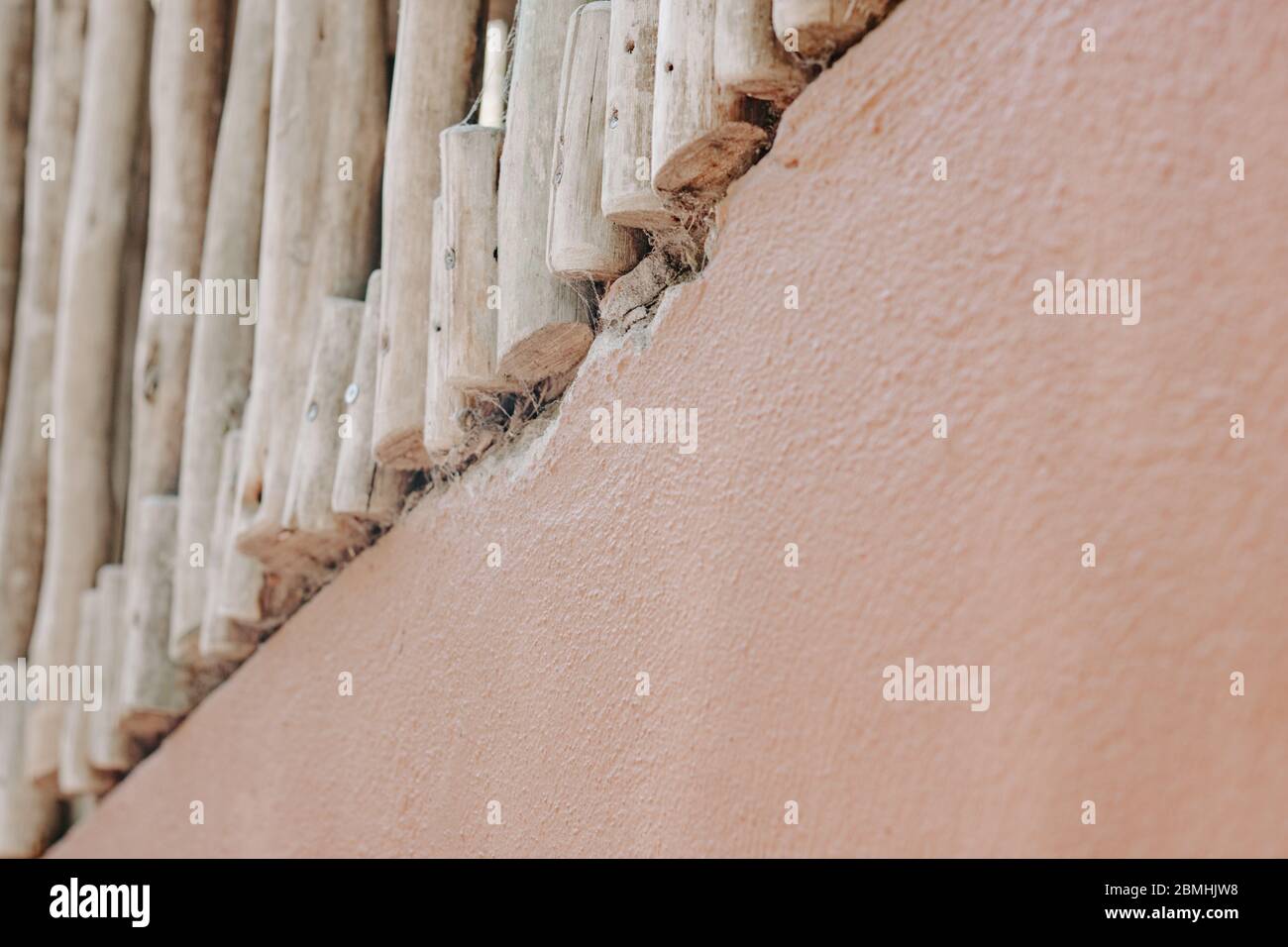 Nature background, terracotta wall, wood fence, sticks, neutral, plain, peach wall, minimal background, abstract, brown, browns, blog image Stock Photo