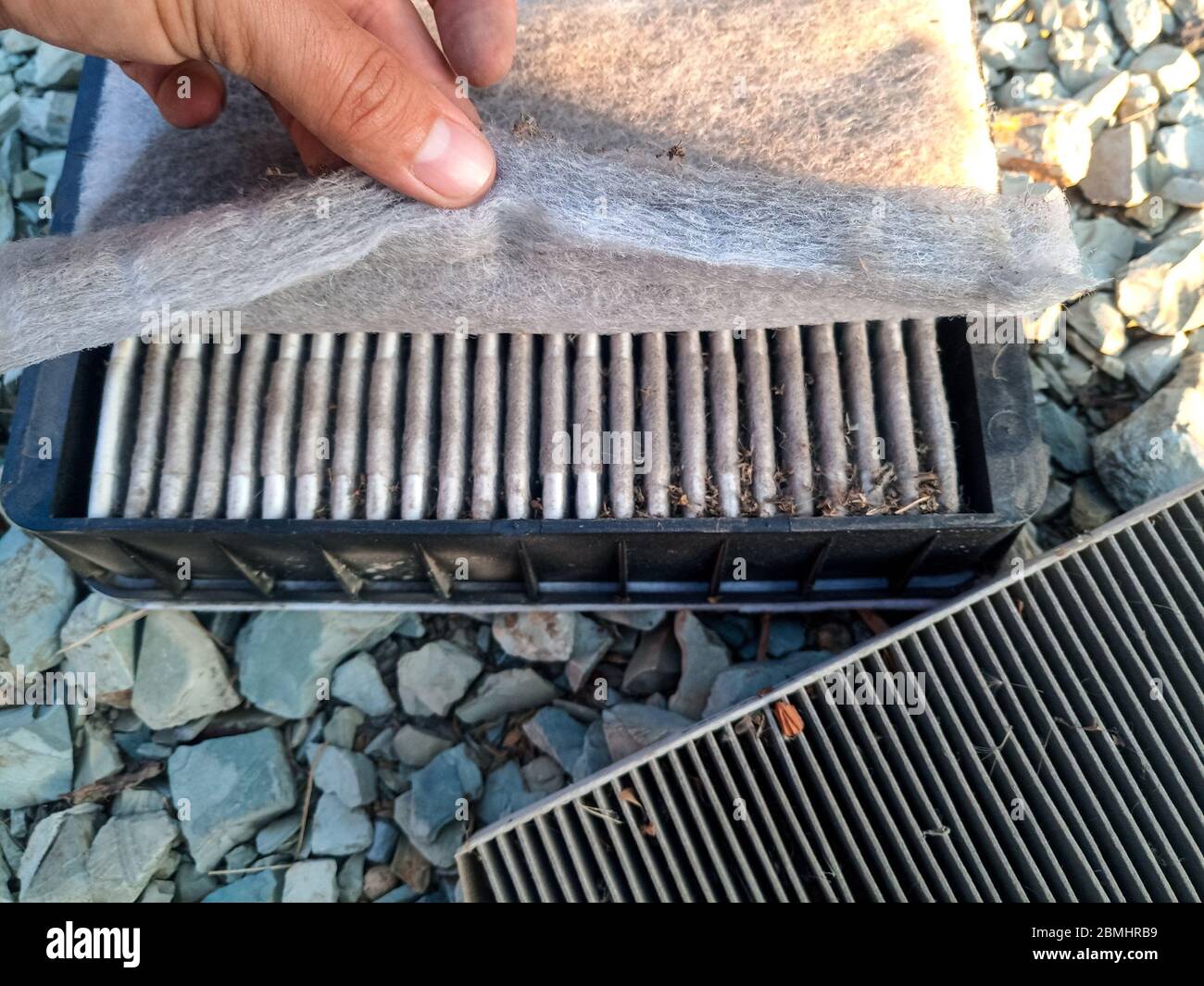 An old dirty filter out of the car. Replacing the air filter Stock