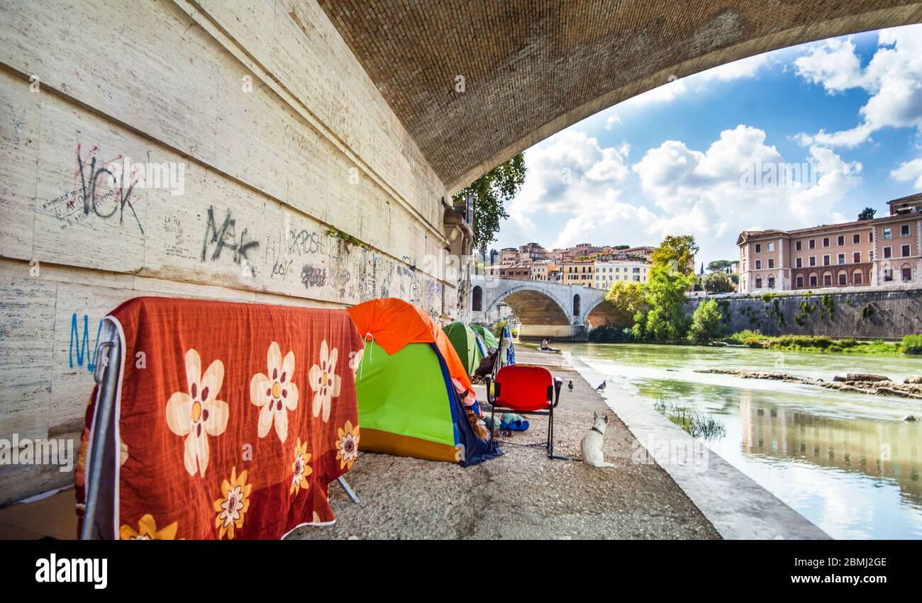 Rome Lazio Italy on October 06, 2019 Tents of homeless people under a bridge on the Tiber Stock Photo