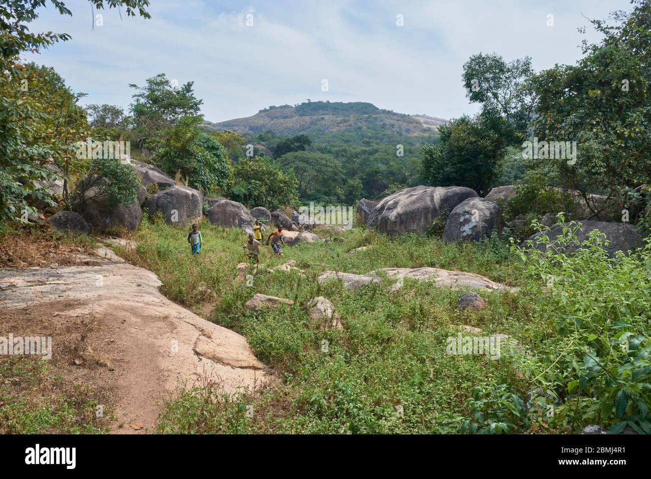 Children walking on a narrow trail in the Eggon Hills. Stock Photo