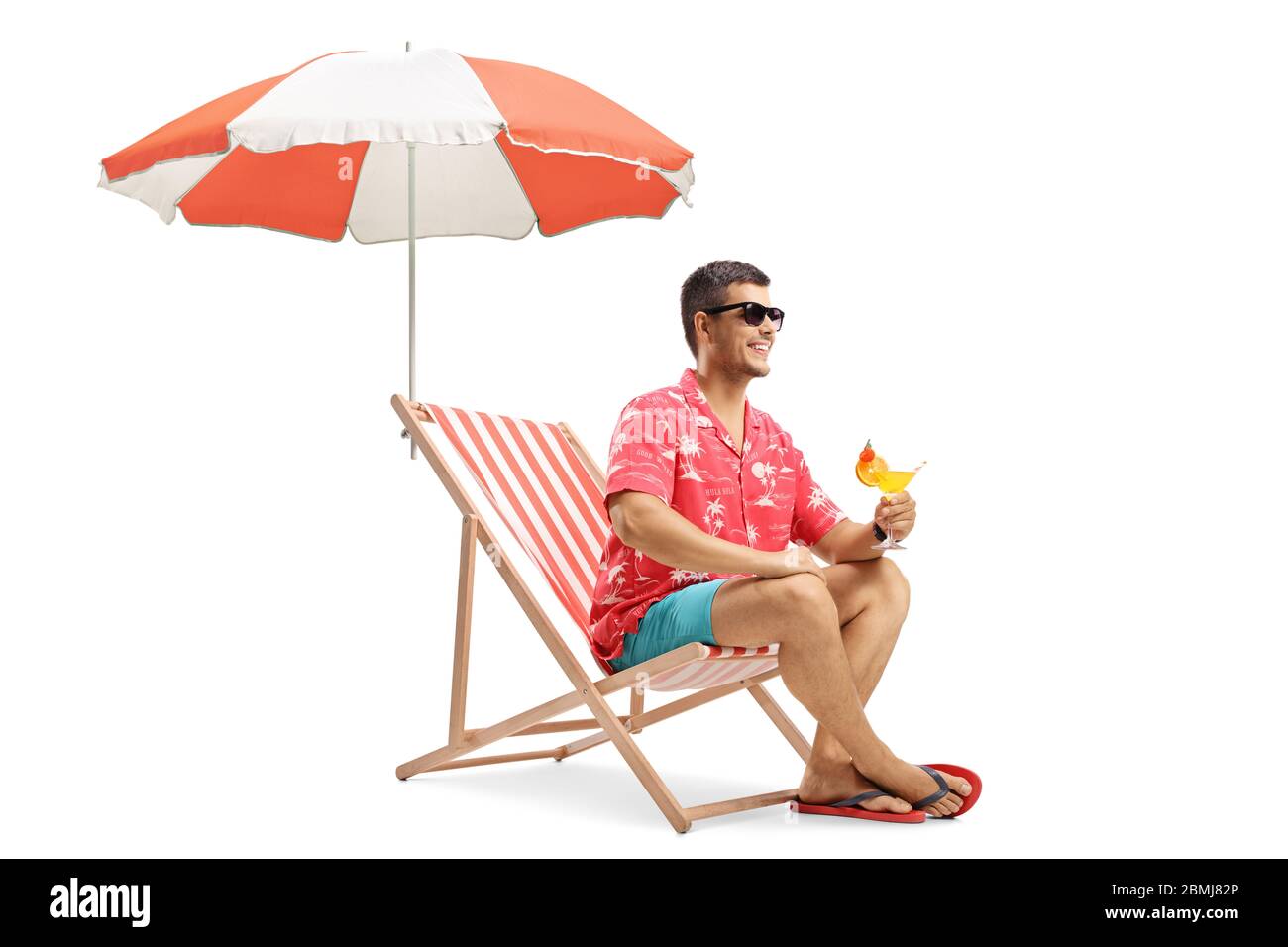 Man sitting on deckchair under umbrella on beach hi-res stock photography  and images - Alamy