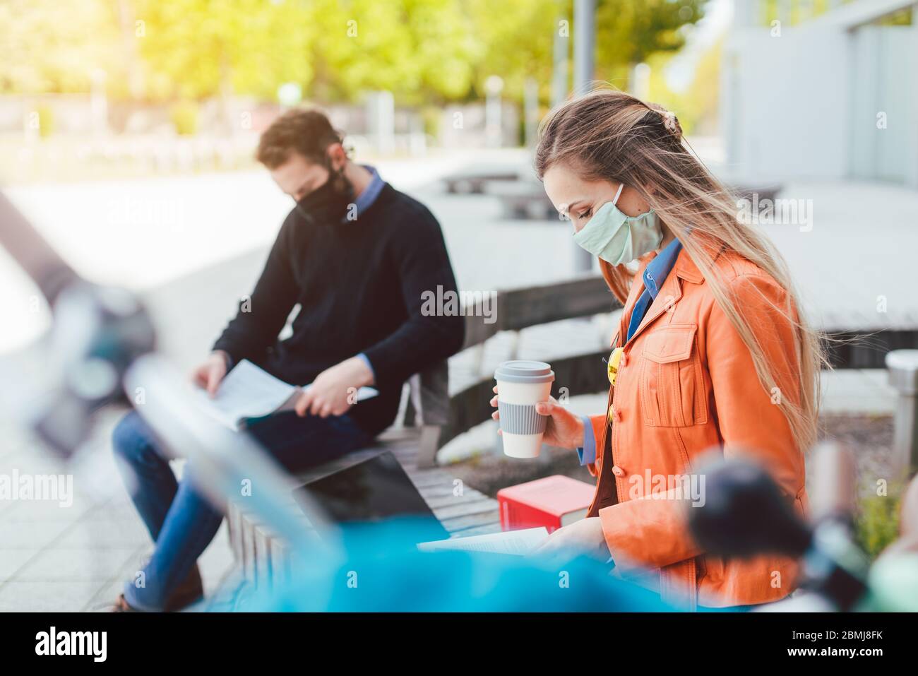 Two college students learning while keeping social distance Stock Photo