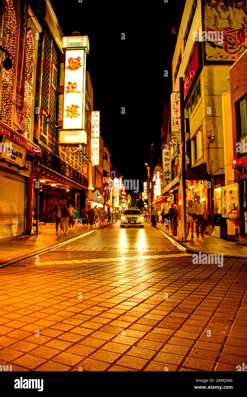 An alley in Chinatown that is lite up by restaurants and lanterns. Stock Photo