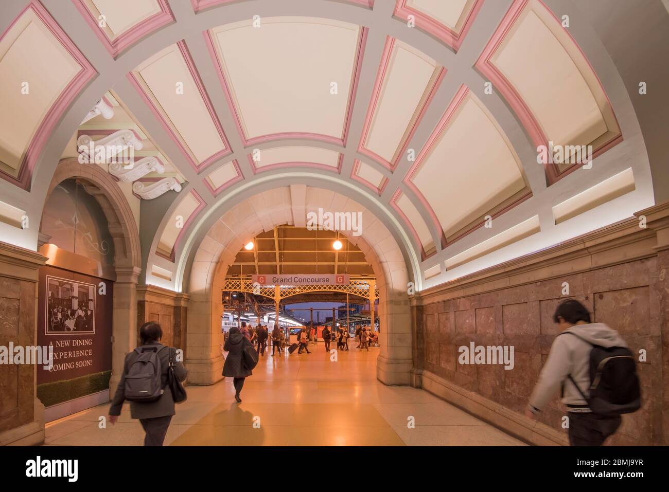 Commuters rushing through an entrance walkway leading to the main concourse at Sydney's Central Station in Australia on their evening trip home Stock Photo