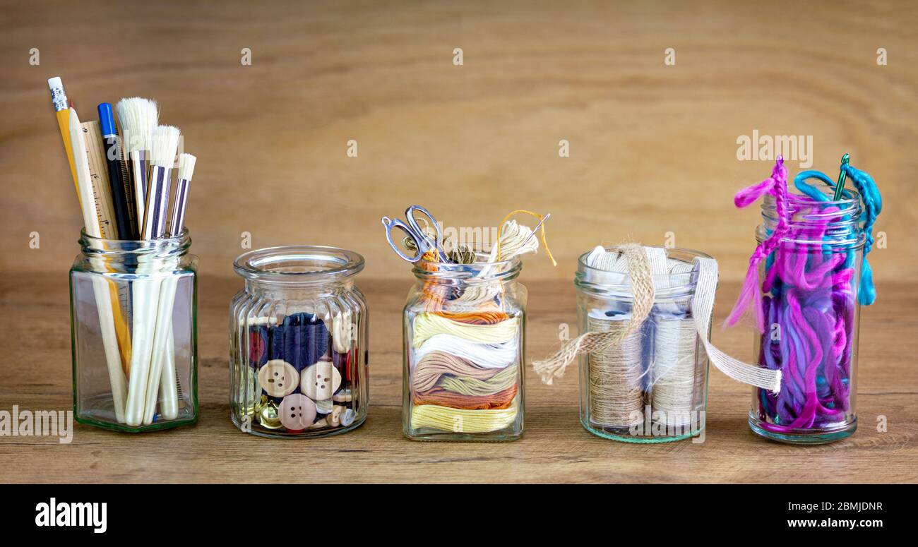 Reused jars reused for storing crafting materials, recycling at home for sustainable living, save money and zero waste Stock Photo