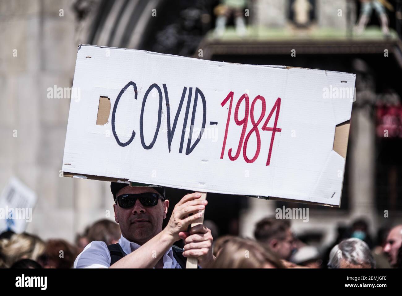 Munich, Bavaria, Germany. 9th May, 2020. Covid 1984 slogans referring to the Orwell book. Despite ongoing relaxing measures, a "Querfront"" (cross-front) mixture of 3,000 conspiracy theorists, QAnon followers, right-extremists, AfD figures, neonazis, hooligans, and Widerstand2020 assembled for a third weekend in Munich's city center, primarily at Marienplatz, to demonstrate for restoration of the Grundgesetz amid the Coronavirus crisis. Such demos and daily mini-demos with an overwhelming 2015-2016 Pegida quality are being staged throughout Germany, with two attacks on journalists for ARD Stock Photo
