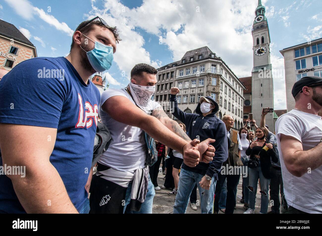 Munich, Bavaria, Germany. 9th May, 2020. Demonstrators who were part of a hooligan block were trying to incite a conflict or riot against police began changing ''wir sind das Volk'' and ''Widerstand'', as well as approaching police intimidatingly. Despite ongoing relaxing measures, a 'Querfront'' (cross-front) mixture of 3,000 conspiracy theorists, QAnon followers, right-extremists, AfD figures, neonazis, hooligans, and Widerstand2020 assembled for a third weekend in Munich's city center, primarily at Marienplatz, to demonstrate for restoration of the Grundgesetz amid the Coronavirus crisis Stock Photo