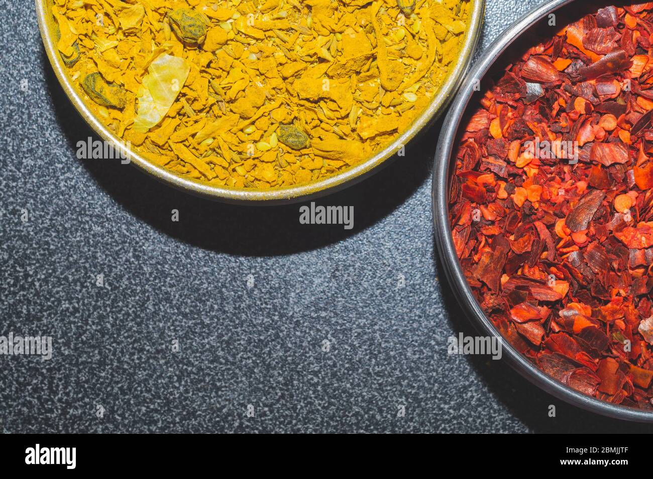 Dried chili pepper. curry spice. paprika and curcuma. red and yellow seasoning. condiment in the jars. copy space Stock Photo