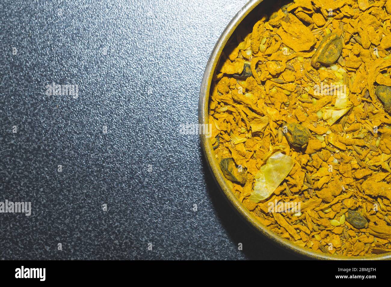 Curry spice in the jar. curcuma seasoning. yellow condiment close up. copy space Stock Photo