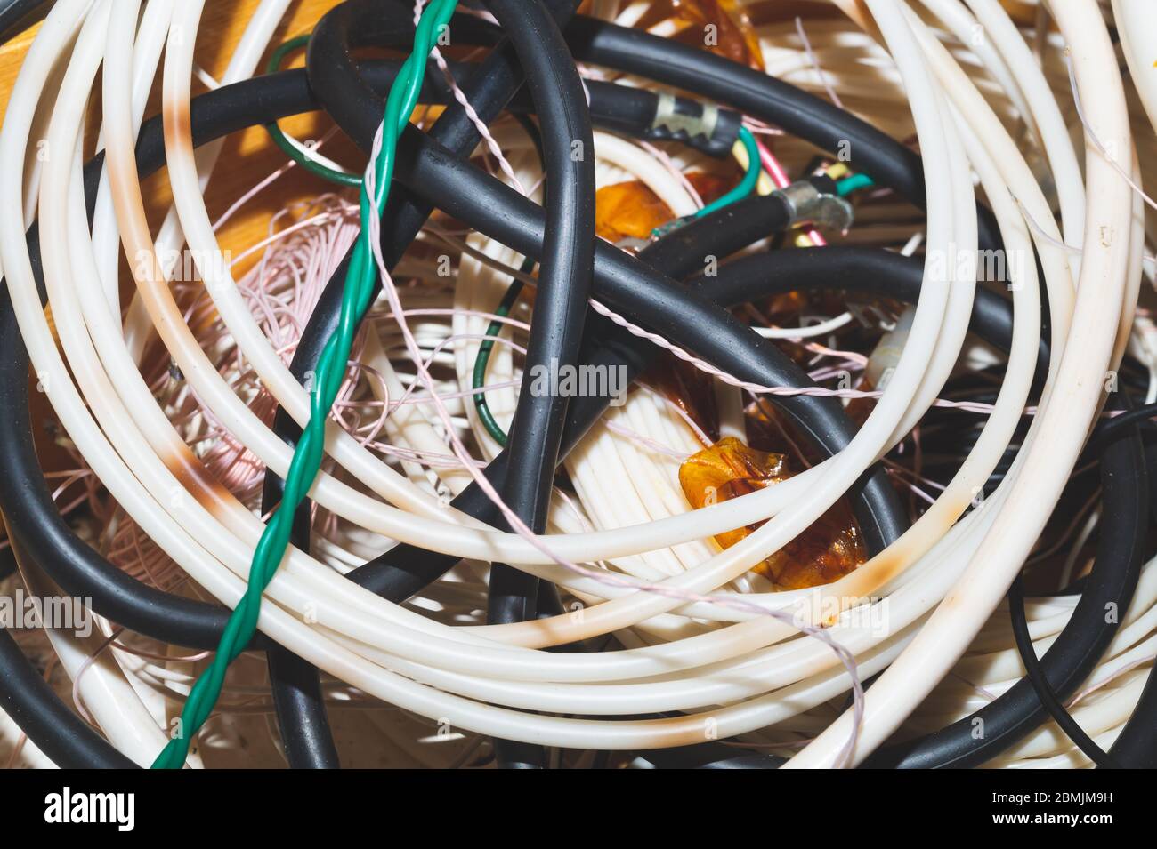 Old hoses and wires close up. twisted hosepipe. gardening equipment Stock Photo