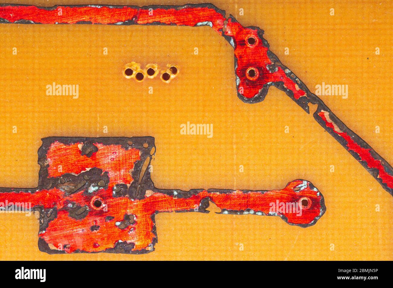 Handmade circuit board with red soldered tracks. industrial background. textolite with soldering Stock Photo