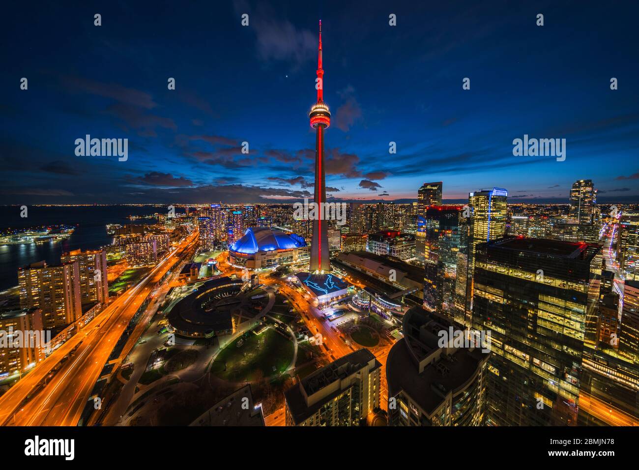 Toronto, Ontario, Canada, panoramic view of Toronto cityscape including architectural landmark CN Tower illuminated at night. Stock Photo