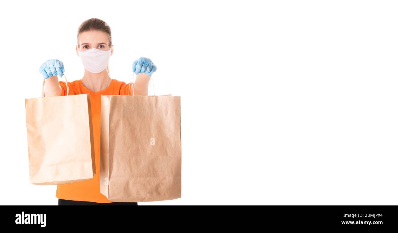 young girl in a mask and an orange t-shirt and latex gloves holds two ...