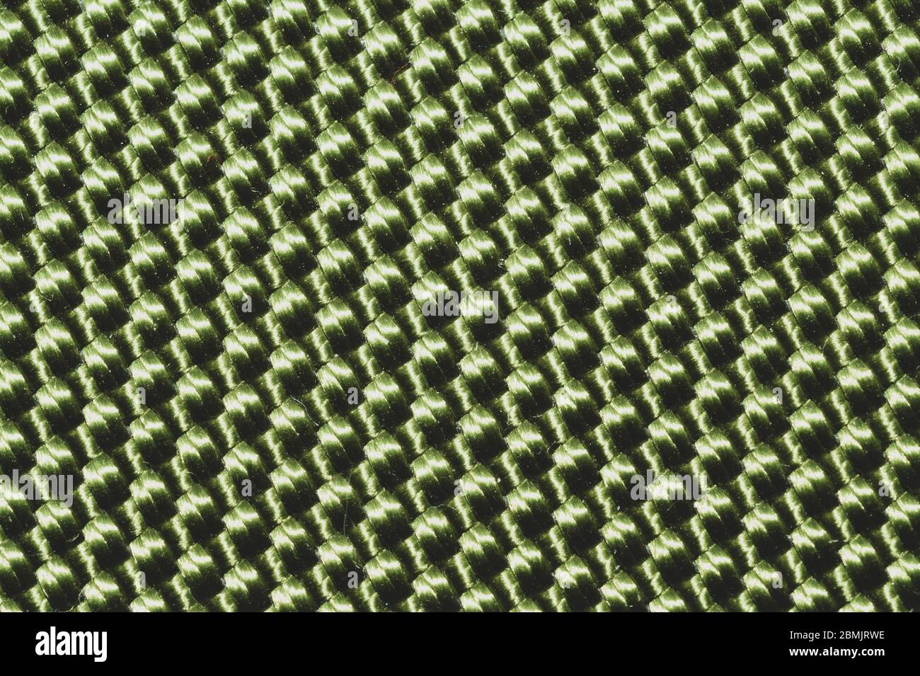 Synthetic fabric texture close up. green braided surface. woven background. stitches of fibers Stock Photo