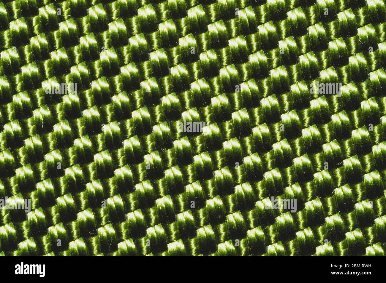 Synthetic fabric texture close up. green braided surface. woven background. stitches of fibers Stock Photo