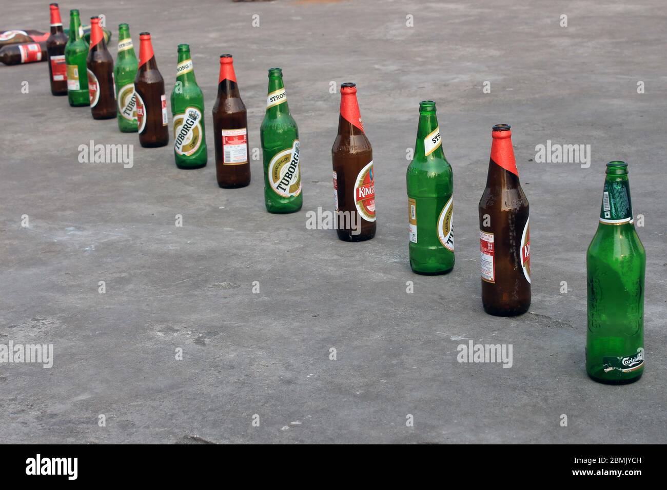 Kolkata, West Bengal on 16th March in 2016 : Empty beer bottle in a row on the floor. Concept of social distancing issue. Stock Photo