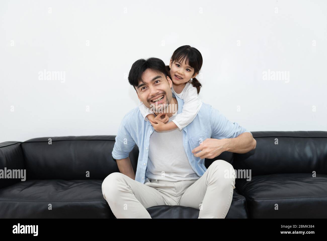 A pair of young Asian father and daughter are playing in the living room Stock Photo