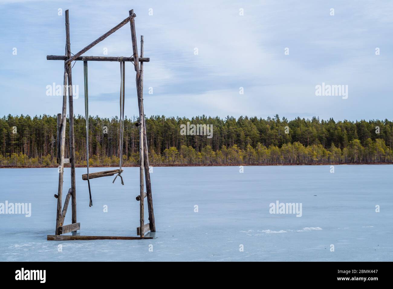 Wooden swing on a frozen lake. solitude concept. nature landscape Stock Photo
