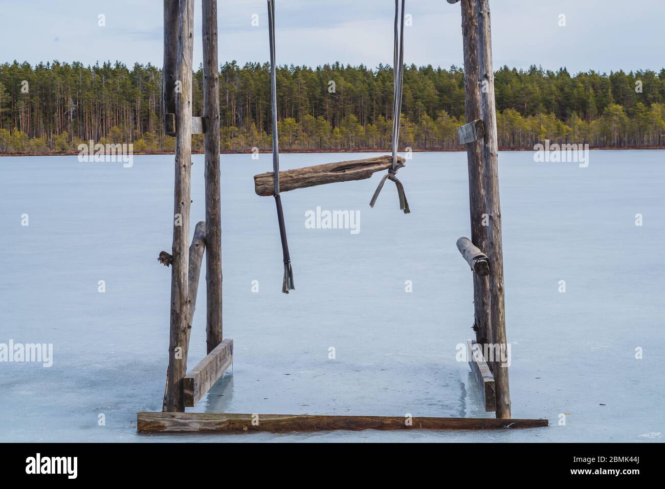 Wooden swing on a frozen lake. solitude concept. nature landscape Stock Photo