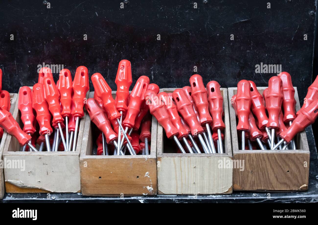 Screwdrivers at checkout in front of the store. Our red handle is stalked. It is unused and new. Close up. Stock Photo
