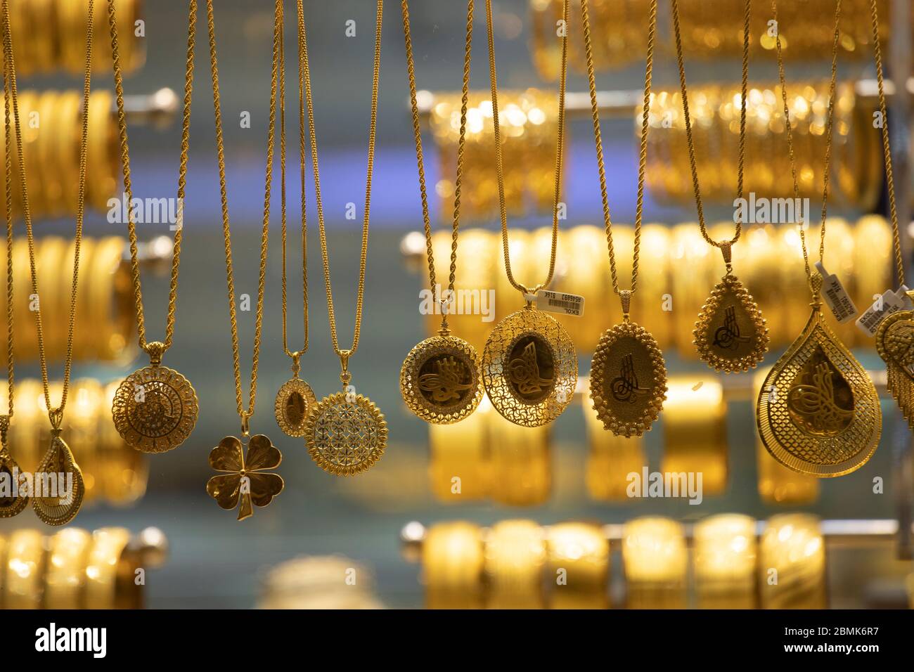 Gold necklaces and bracelets designed in various ways in front of the