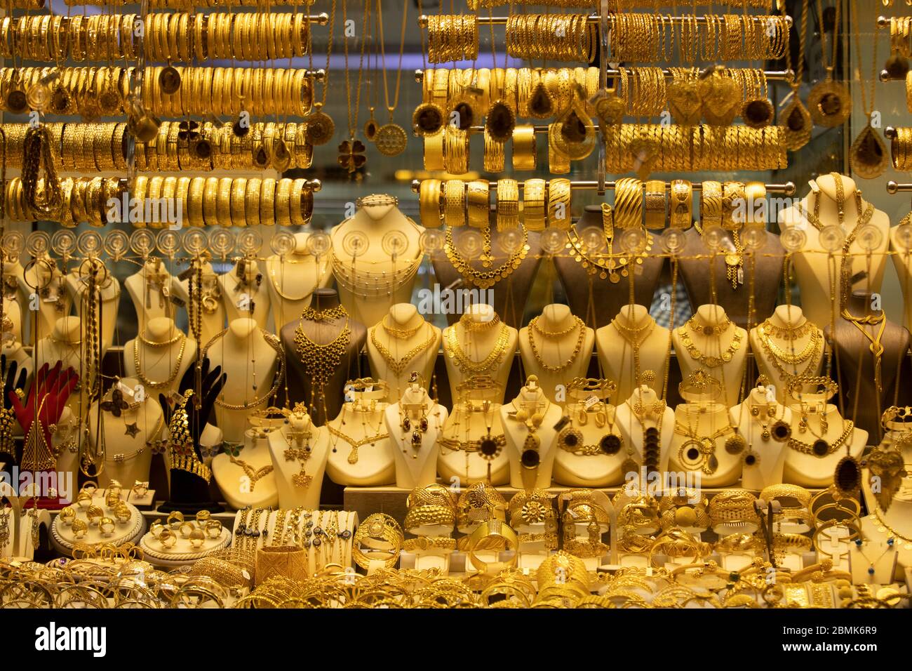 Gold necklaces and bracelets designed in various ways in front of the