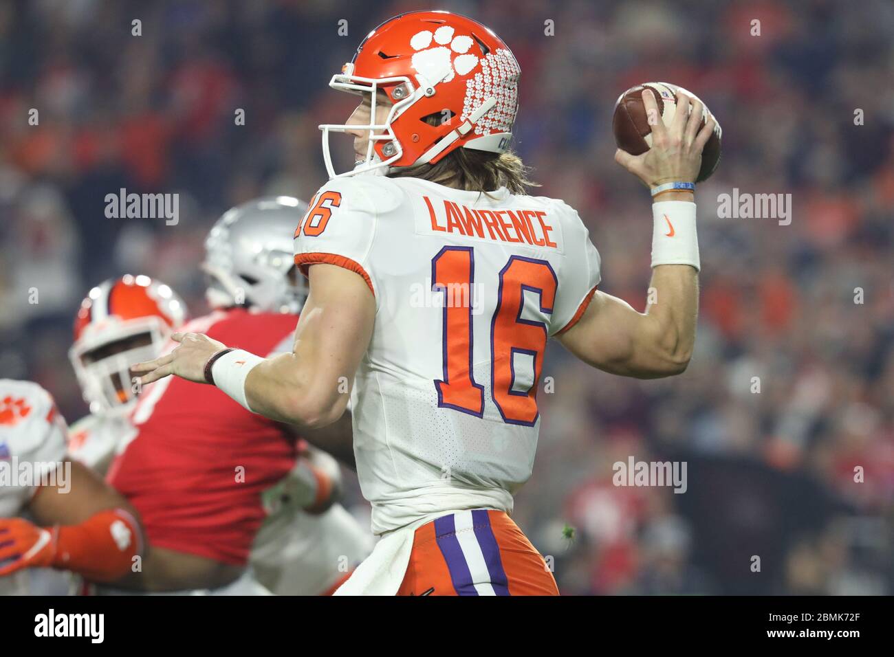 Trevor Lawrence (16), Clemson quarterback, throws a pass during the 2019 CFP semifinal showdown against Ohio State in the Fiesta Bowl. Stock Photo