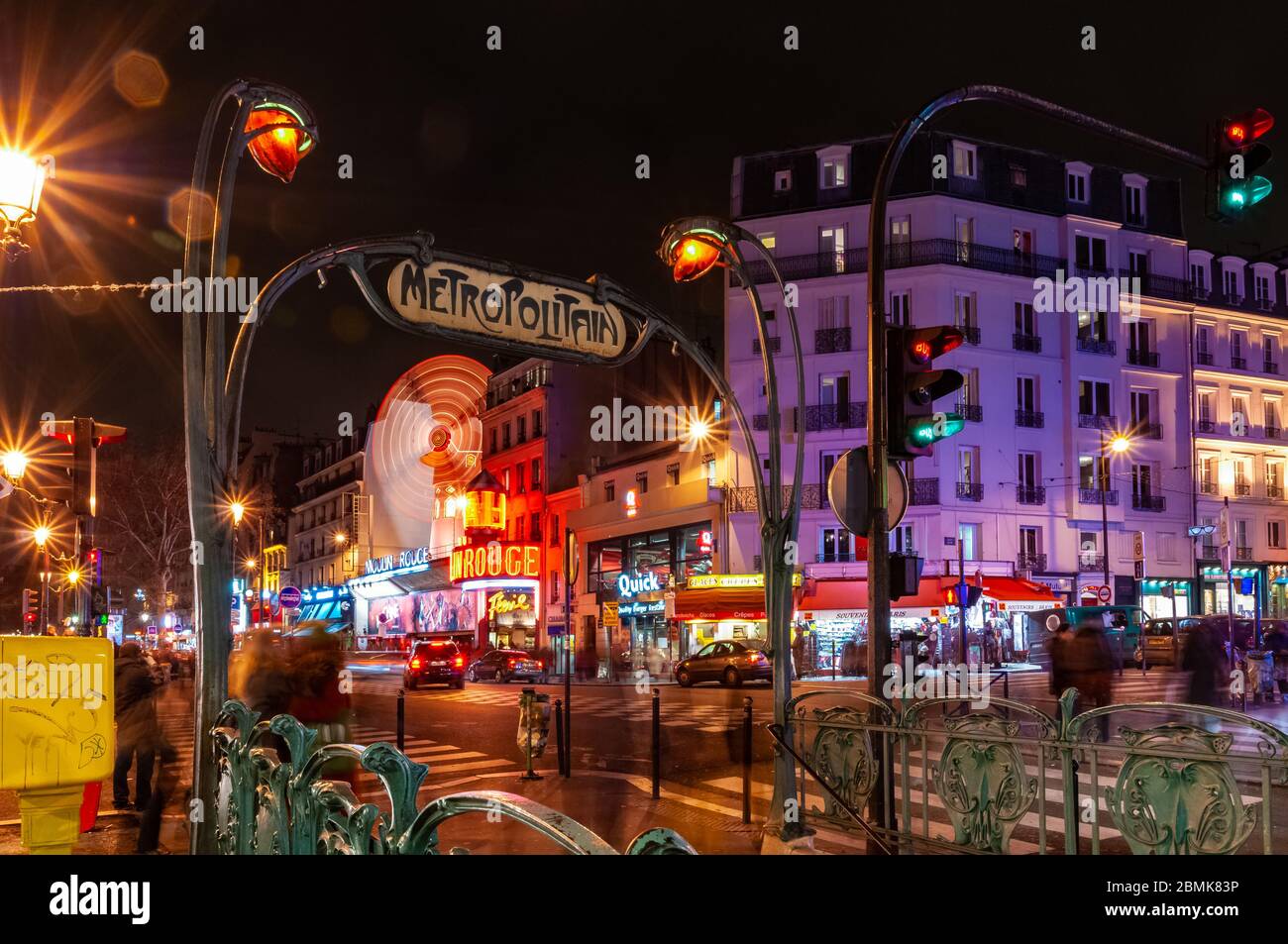 Paris, France. January 28th, 2012. Metro entrance near the Moulin Rouge at night with beautiful city lights. Stock Photo