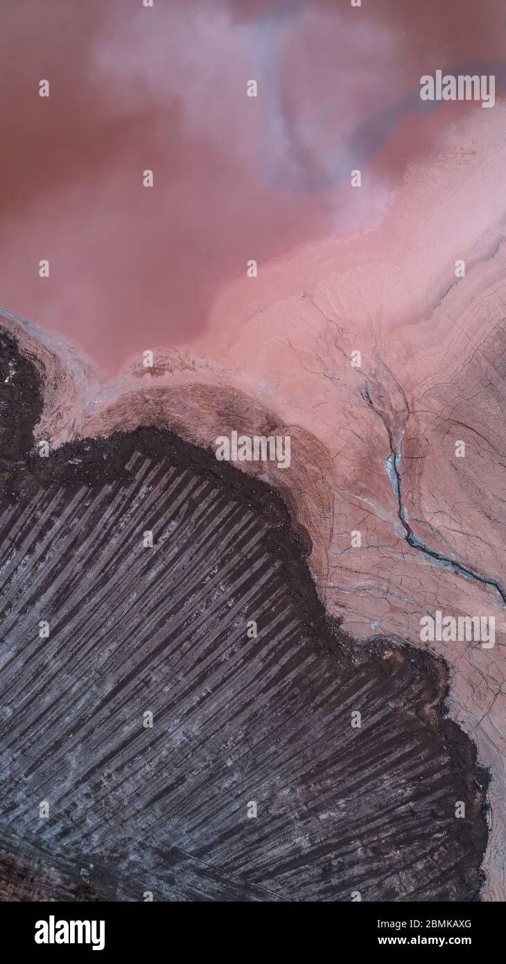 Abstract Aerial View of Red Tailing Ponds with Various Textures Stock Photo