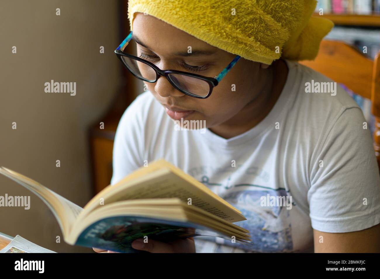 Little Indian girl studies at home maintaining social distance during lock down period for Covid-19. Stock Photo