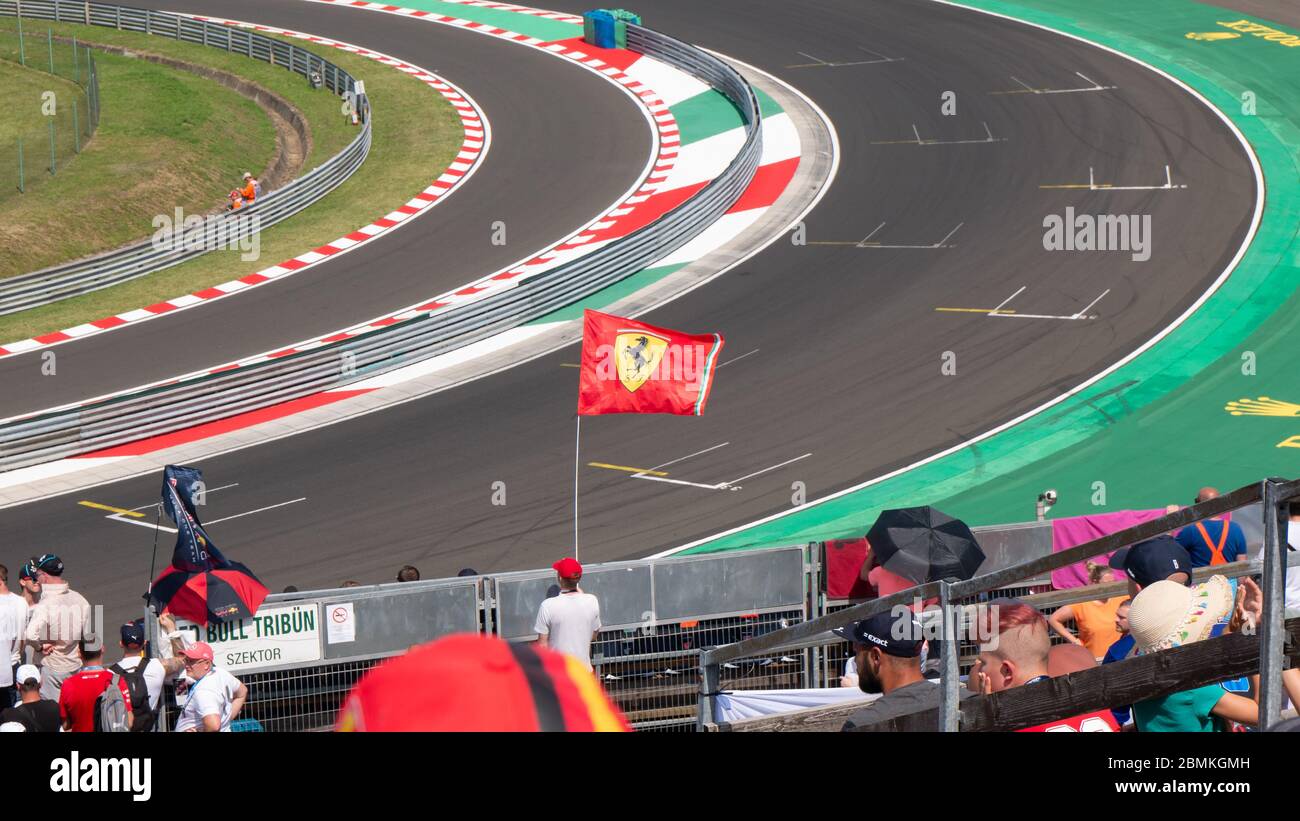 Mogyorod Hungary 28 09 2019: A Ferrari fan holds the Ferrari flag on a racetrack. Stock Photo