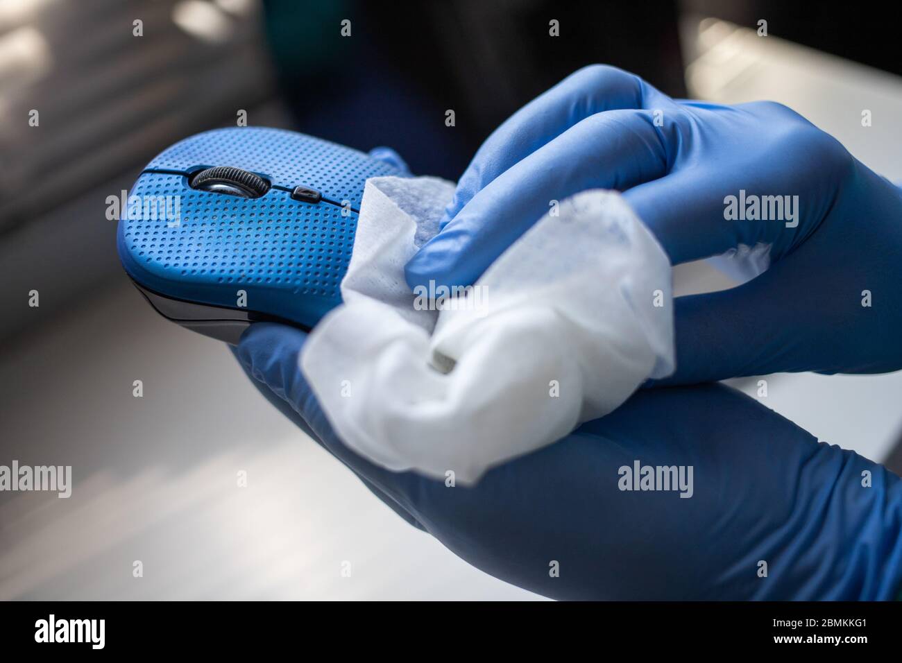 Office sanitizing wipe wiping mouse and mousepad with disinfecting wipes. Coronavirus COVID19